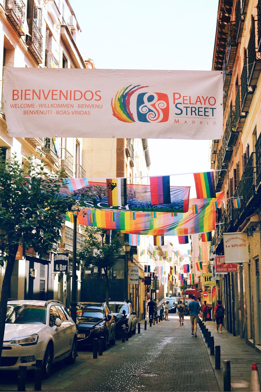 Vibrant Madrid street scene with colorful flags and cultural celebrations